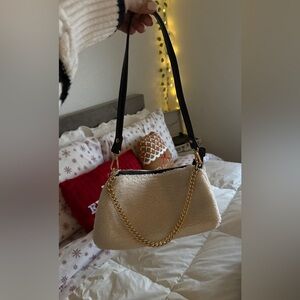 A fur shoulder bag with gold chain.